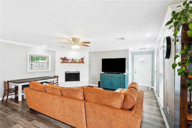 5924 Bellingham Pl, Metairie, LA 70003 - living area with ornamental molding, ceiling fan, dark wood-type flooring, a fireplace with raised hearth, and recessed lighting