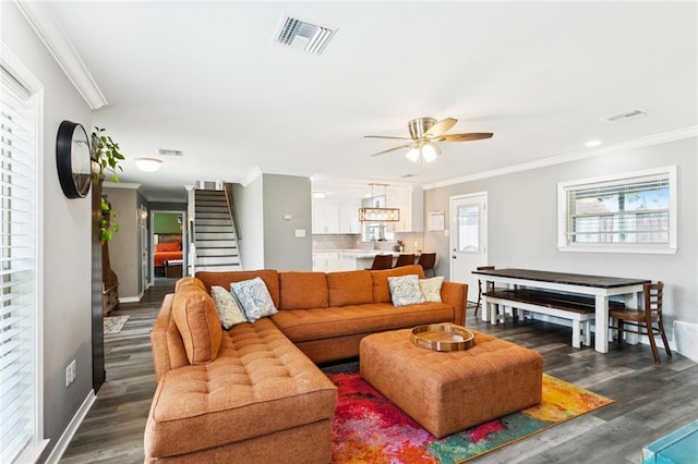 5924 Bellingham Pl, Metairie, LA 70003 - living area with ornamental molding, a ceiling fan, dark wood-type flooring, and stairway
