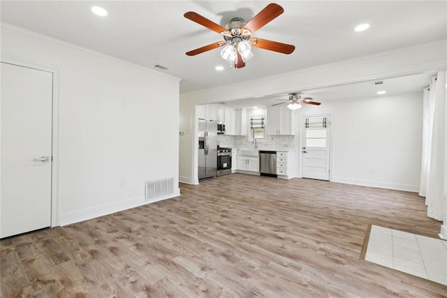 1112 Kent Ave, Metairie, LA 70001 - unfurnished living room with ornamental molding, a ceiling fan, light wood-type flooring, and recessed lighting