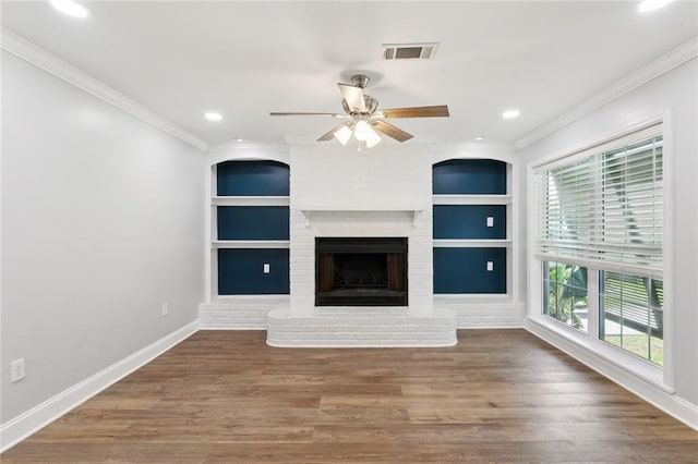 8021 Shirley St, Metairie, LA 70003 - unfurnished living room with built in shelves, ornamental molding, ceiling fan, a brick fireplace, and wood finished floors