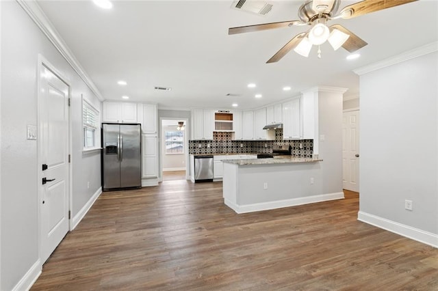 8021 Shirley St, Metairie, LA 70003 - kitchen featuring appliances with stainless steel finishes, ornamental molding, recessed lighting, decorative backsplash, and ceiling fan