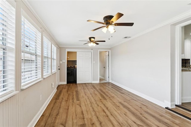 8021 Shirley St, Metairie, LA 70003 - unfurnished living room featuring light wood finished floors, ceiling fan, ornamental molding, and washer and clothes dryer