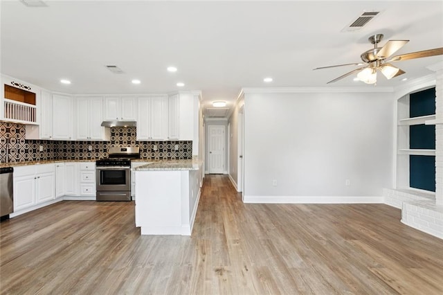 8021 Shirley St, Metairie, LA 70003 - kitchen featuring appliances with stainless steel finishes, open shelves, ceiling fan, white cabinetry, and backsplash