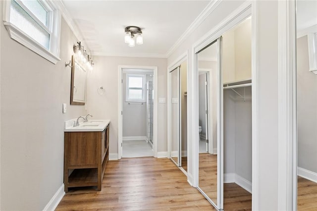 8021 Shirley St, Metairie, LA 70003 - full bath with vanity, wood finished floors, a spacious closet, and crown molding