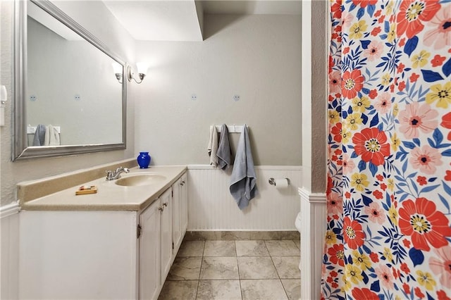 2638 Gallinghouse St, New Orleans, LA 70131 - bathroom with vanity, wainscoting, a shower with curtain, and tile patterned floors