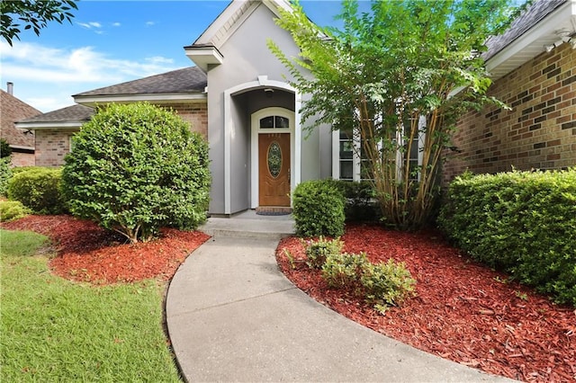 1022 Forest Ridge Loop, Pearl River, LA 70452 - entrance to property with roof with shingles, brick siding, a garage, and stucco siding