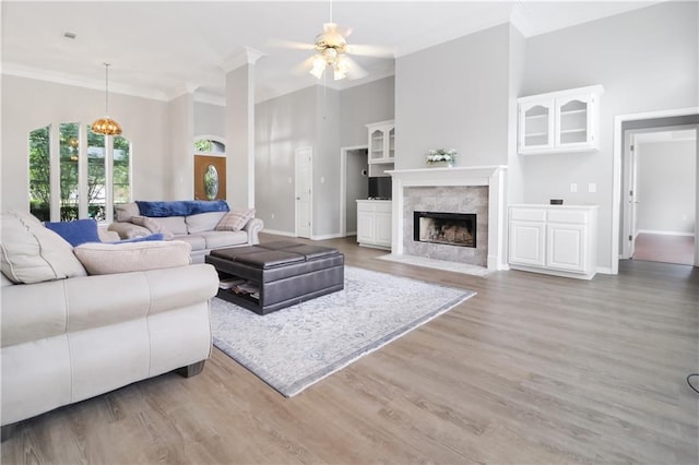 1022 Forest Ridge Loop, Pearl River, LA 70452 - living area featuring crown molding, a ceiling fan, light wood-style floors, and a fireplace with flush hearth