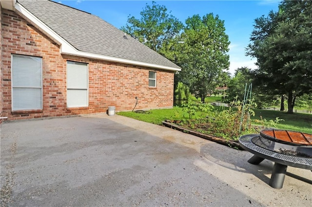 1022 Forest Ridge Loop, Pearl River, LA 70452 - view of side of home featuring brick siding, a shingled roof, and a patio area