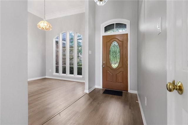 1022 Forest Ridge Loop, Pearl River, LA 70452 - entryway featuring a chandelier, wood finished floors, and ornamental molding
