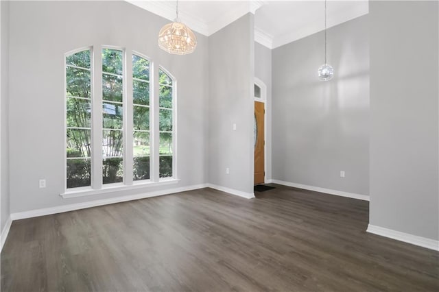 1022 Forest Ridge Loop, Pearl River, LA 70452 - empty room featuring a chandelier, ornamental molding, dark wood-type flooring, and a towering ceiling