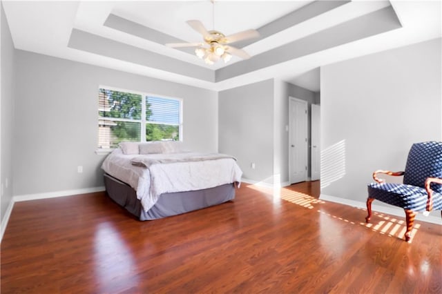 1022 Forest Ridge Loop, Pearl River, LA 70452 - bedroom featuring a tray ceiling, wood finished floors, and ceiling fan