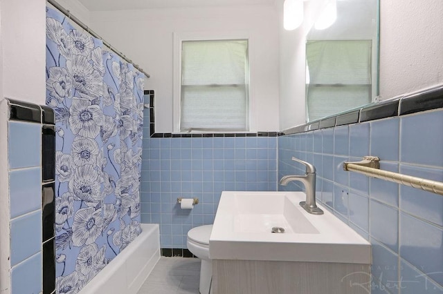 405 Jade Ave, Metairie, LA 70003 - bathroom with tile walls, shower / bath combo with shower curtain, vanity, and wainscoting