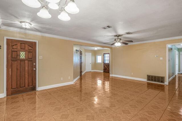 1832 Faith Pl, Gretna, LA 70056 - unfurnished room with ornamental molding, ceiling fan, light tile patterned floors, and a chandelier