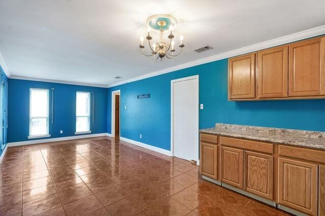 1832 Faith Pl, Gretna, LA 70056 - kitchen featuring ornamental molding, a chandelier, brown cabinetry, tile patterned floors, and open floor plan