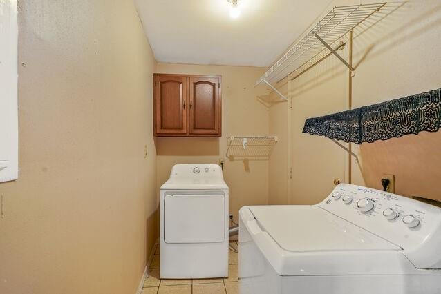 1832 Faith Pl, Gretna, LA 70056 - laundry room featuring separate washer and dryer, light tile patterned flooring, and cabinet space