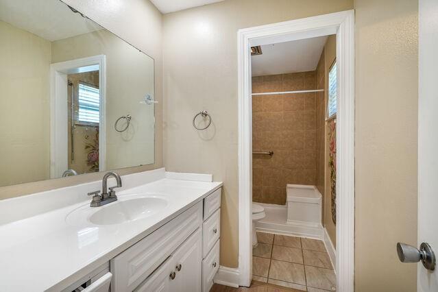 1832 Faith Pl, Gretna, LA 70056 - bathroom with vanity, curtained shower, and healthy amount of natural light