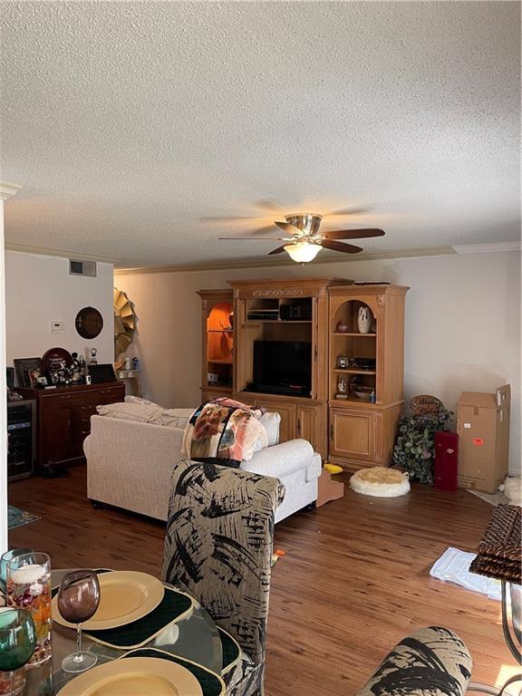722 Marina Dr Unit 722, Slidell, LA 70458 - living room with wood finished floors, a textured ceiling, ceiling fan, and ornamental molding