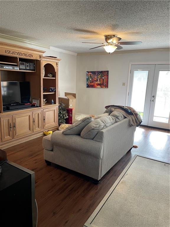 722 Marina Dr Unit 722, Slidell, LA 70458 - living room with wood finished floors, ornamental molding, a ceiling fan, and a textured ceiling