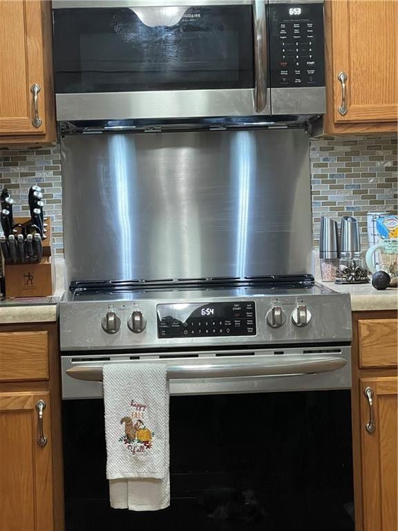722 Marina Dr Unit 722, Slidell, LA 70458 - kitchen view of appliances with stainless steel finishes, decorative backsplash, and light countertops