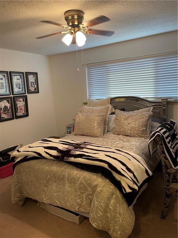 722 Marina Dr Unit 722, Slidell, LA 70458 - bedroom with carpet, ceiling fan, and a textured ceiling
