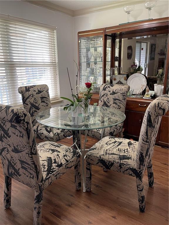 722 Marina Dr Unit 722, Slidell, LA 70458 - dining space featuring wood finished floors, crown molding, and plenty of natural light