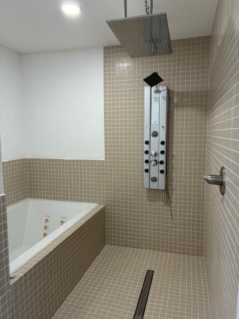 29 Snipe St, New Orleans, LA 70124 - bathroom featuring tiled shower, a jetted tub, and tile patterned flooring