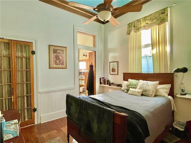 91315 Arabella St, New Orleans, LA 70115 - bedroom featuring wood finished floors, a wainscoted wall, and a ceiling fan