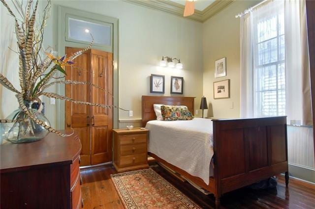 91315 Arabella St, New Orleans, LA 70115 - bedroom featuring ornamental molding and hardwood / wood-style flooring