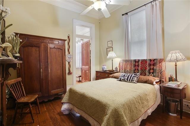 91315 Arabella St, New Orleans, LA 70115 - bedroom with dark wood-style flooring, ornamental molding, and ceiling fan