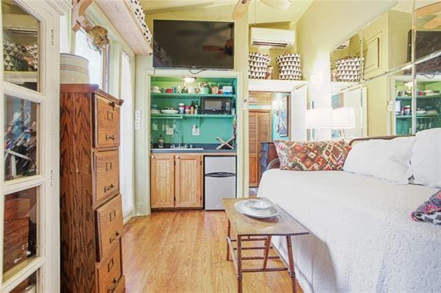 91315 Arabella St, New Orleans, LA 70115 - bar area with fridge, a wall mounted air conditioner, light wood-style floors, and ceiling fan