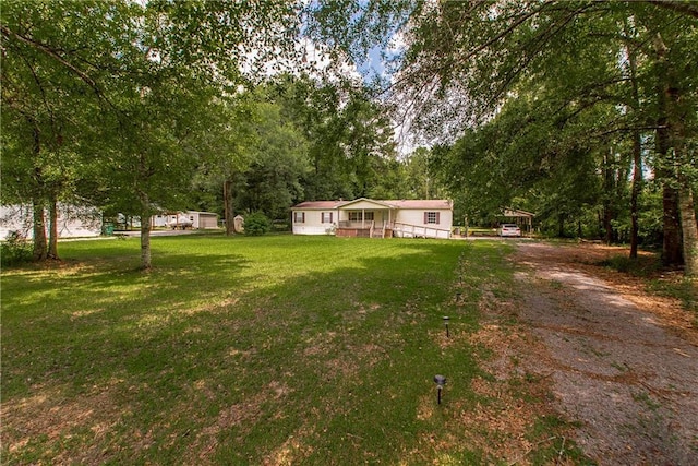 25169 Stepp Rd, Robert, LA 70455 - view of grassy yard with driveway and a carport