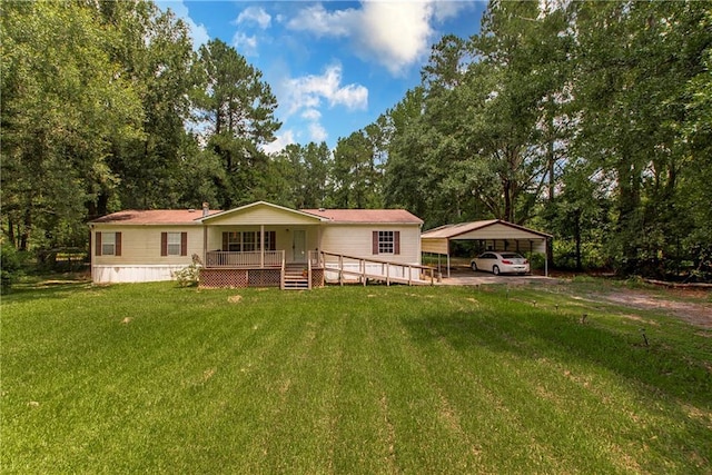 25169 Stepp Rd, Robert, LA 70455 - view of front of house with a detached carport, a front yard, view of wooded area, and a wooden deck