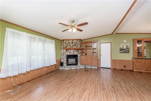 25169 Stepp Rd, Robert, LA 70455 - unfurnished living room featuring wood finished floors, ceiling fan, ornamental molding, a wainscoted wall, and vaulted ceiling
