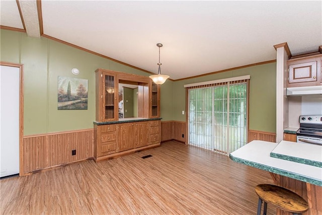 25169 Stepp Rd, Robert, LA 70455 - unfurnished dining area with wainscoting, wooden walls, light wood-type flooring, and crown molding