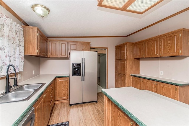 25169 Stepp Rd, Robert, LA 70455 - kitchen with appliances with stainless steel finishes, lofted ceiling, crown molding, light wood-type flooring, and a textured ceiling