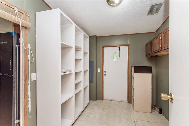 25169 Stepp Rd, Robert, LA 70455 - washroom featuring light flooring, electric panel, and a textured ceiling