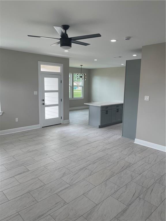 680 Hunterbrook Dr, Gretna, LA 70056 - empty room with a ceiling fan, a chandelier, recessed lighting, light marble finish flooring, and a smoke detector