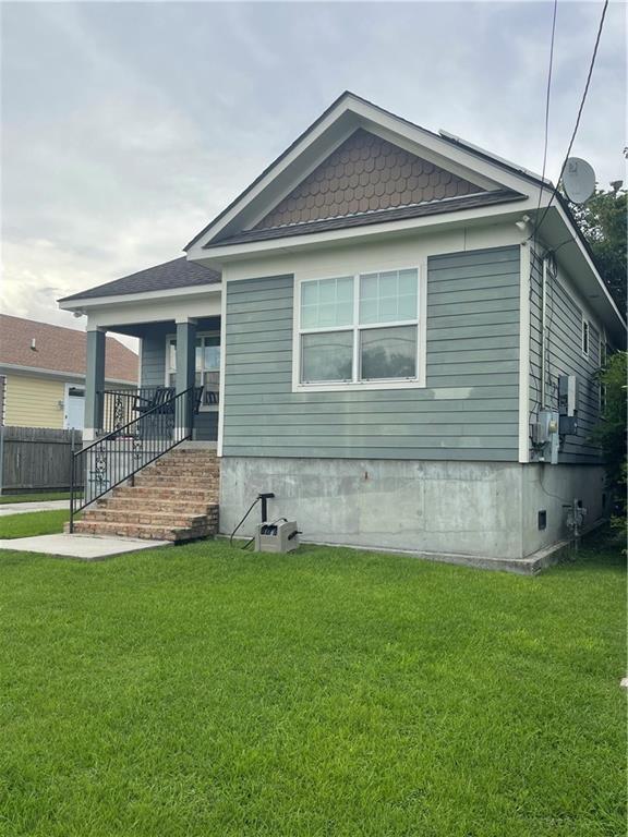 5817 Providence Pl, New Orleans, LA 70126 - view of front of house featuring covered porch and stairs