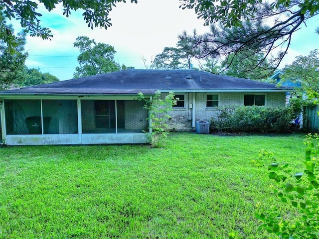 218 Mockingbird Ln, Slidell, LA 70458 - rear view of property featuring a yard, a sunroom, brick siding, and a shingled roof