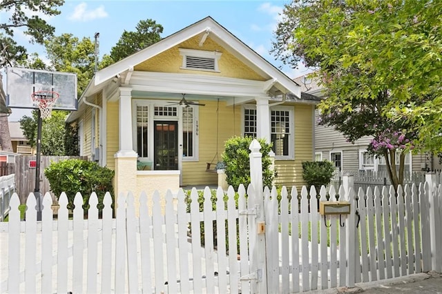 1906 Audubon St, New Orleans, LA 70118 - view of front of property featuring a fenced front yard, a gate, and ceiling fan