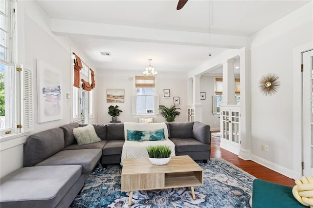 1906 Audubon St, New Orleans, LA 70118 - living area with wood finished floors, decorative columns, and a chandelier