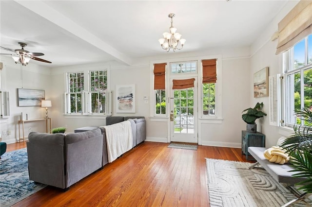 1906 Audubon St, New Orleans, LA 70118 - living area featuring wood-type flooring, a chandelier, beamed ceiling, and a ceiling fan