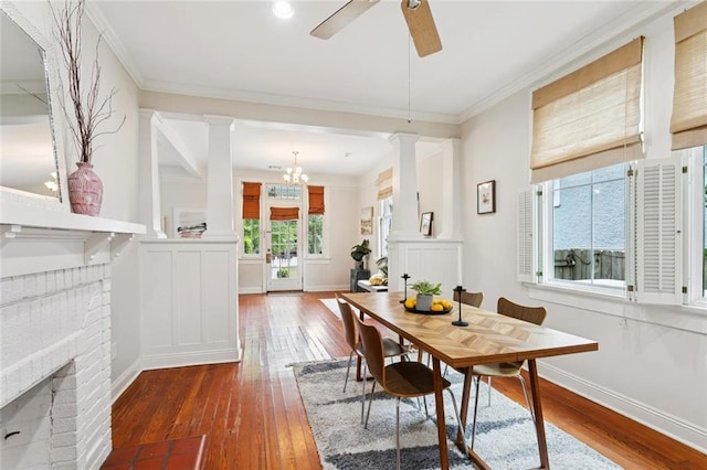 1906 Audubon St, New Orleans, LA 70118 - dining area with hardwood / wood-style floors, decorative columns, ornamental molding, a ceiling fan, and a fireplace