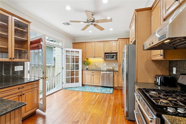 1906 Audubon St, New Orleans, LA 70118 - kitchen with under cabinet range hood, appliances with stainless steel finishes, crown molding, backsplash, and ceiling fan