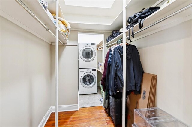 1906 Audubon St, New Orleans, LA 70118 - laundry area featuring stacked washer / dryer and wood finished floors