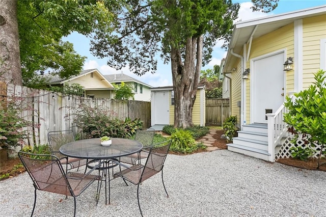 1906 Audubon St, New Orleans, LA 70118 - view of patio / terrace featuring outdoor dining space and a storage shed