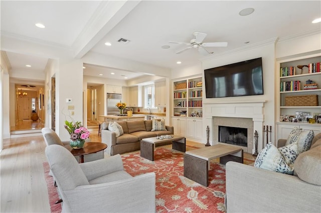 450 Fairway Dr, New Orleans, LA 70124 - living room with crown molding, a ceiling fan, recessed lighting, a fireplace, and light wood-type flooring