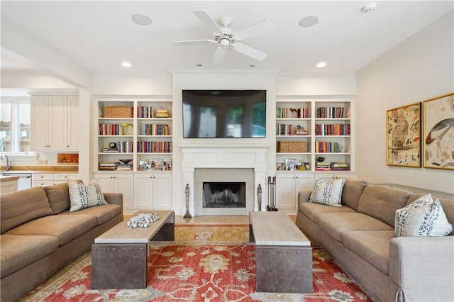 450 Fairway Dr, New Orleans, LA 70124 - living room featuring ceiling fan, crown molding, a fireplace with flush hearth, built in shelves, and recessed lighting