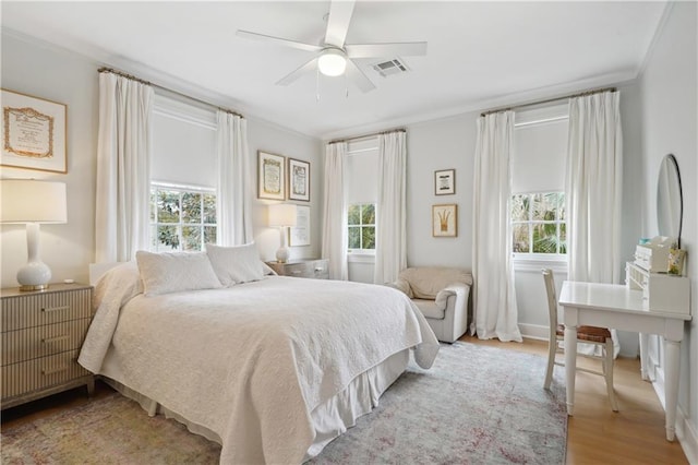 450 Fairway Dr, New Orleans, LA 70124 - bedroom featuring multiple windows, wood finished floors, a ceiling fan, and ornamental molding