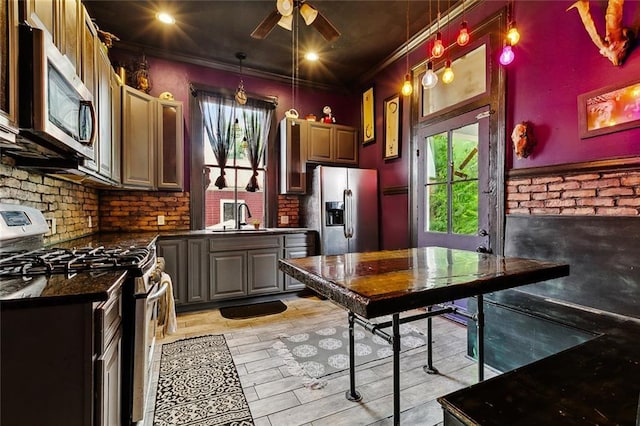 1421 Kentucky St, New Orleans, LA 70117 - kitchen with stainless steel appliances, dark countertops, ceiling fan, decorative light fixtures, and crown molding
